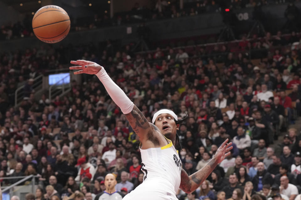 Utah Jazz guard Jordan Clarkson passes the ball during first-half NBA basketball game action against the Toronto Raptors in Toronto, Saturday, Dec. 23, 2023. (Chris Young/The Canadian Press via AP)