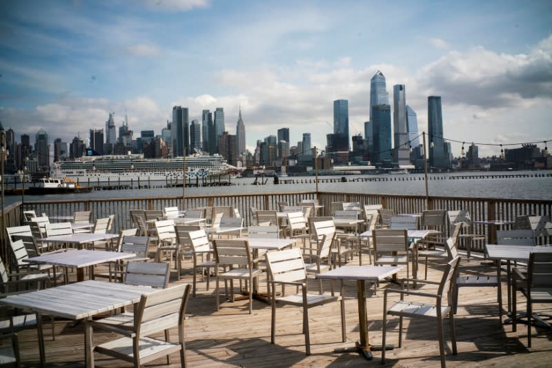 FILE PHOTO: Empty chairs are seen at the deck of a local restaurant that is closed due to the outbreak of coronavirus disease (COVID-19), in Hoboken