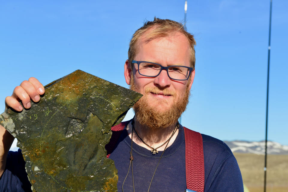Jakob Vinther at the Sirius Passet locality North Greenland with specimen of Timorebestia