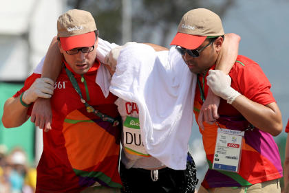 REFILE - CORRECTING ID 2016 Rio Olympics - Athletics - Final - Men&#39;s 50km Race Walk - Pontal - Rio de Janeiro, Brazil - 19/08/2016. Evan Dunfee (CAN) of Canada is being assisted after the race. REUTERS/Damir Sagolj   TPX IMAGES OF THE DAY   FOR EDITORIAL USE ONLY. NOT FOR SALE FOR MARKETING OR ADVERTISING CAMPAIGNS.