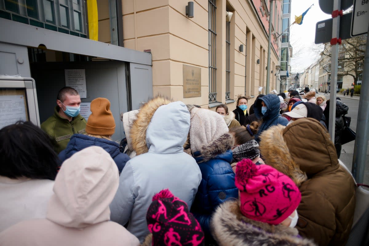 Ukrainian refugees wait in front of the consular department of the Ukrainian embassy in Berlin, Germany, in April 2022 (AP)