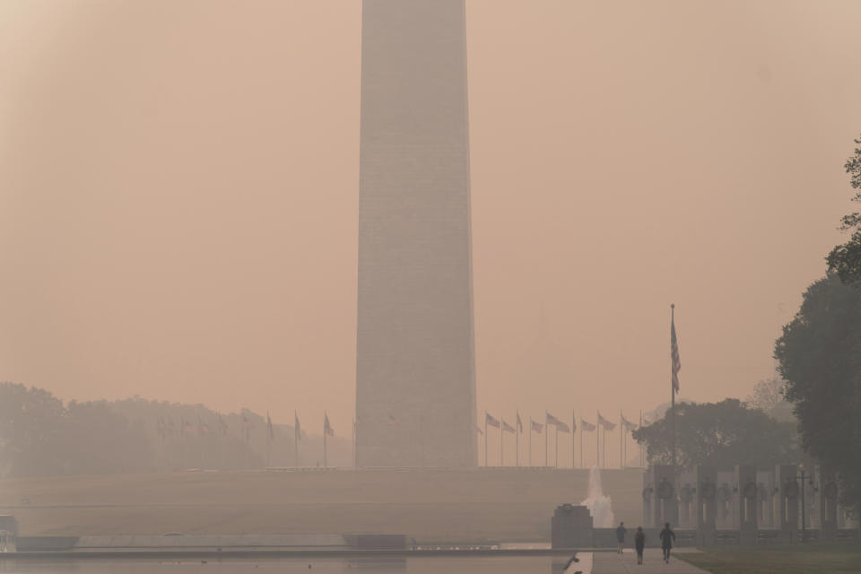 <p>With the Washington Monument in the background and with a thick layer of smoke people run at the National mall Thursday, June 8, 2023, in Washington. Intense Canadian wildfires are blanketing the northeastern U.S. in a dystopian haze, turning the air acrid, the sky yellowish gray and prompting warnings for vulnerable populations to stay inside. (AP Photo/Jose Luis Magana)</p> 