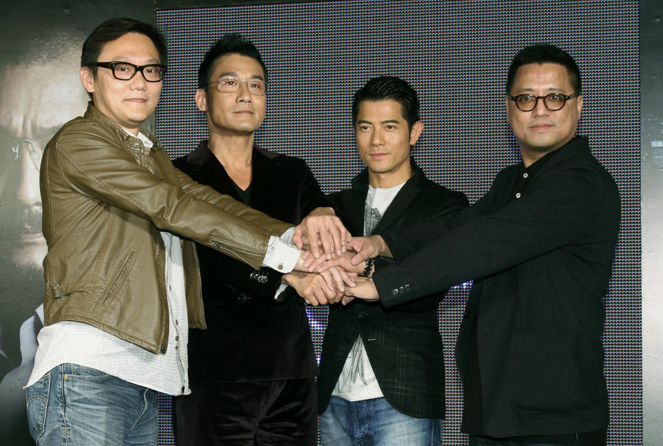 In this photo taken on Monday, Nov. 12, 2012, Hong Kong director Sunny Luk, left, actors Tony Leung Ka Fai, second from left, Aaron Kwok, center, and director Lok Man Leung pose for media during a promotional event for their new film "Cold War" in Taipei, Taiwan. (AP Photo/Chiang Ying-ying)