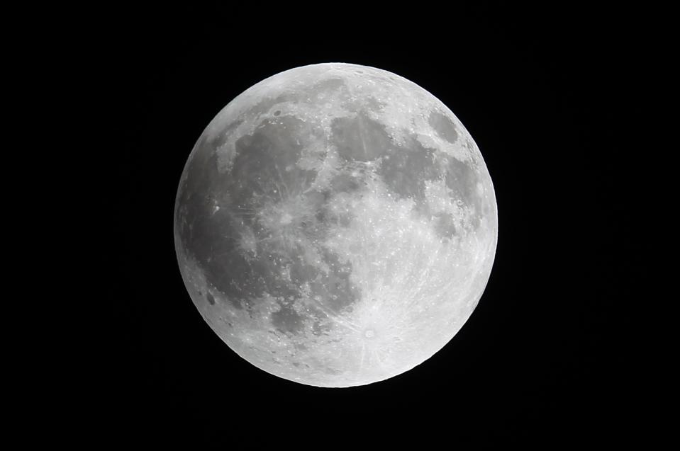 A shadow falls on the moon as it undergoes a total lunar eclipse as seen from Mexico City late April 14, 2014. (REUTERS/Edgard Garrido)