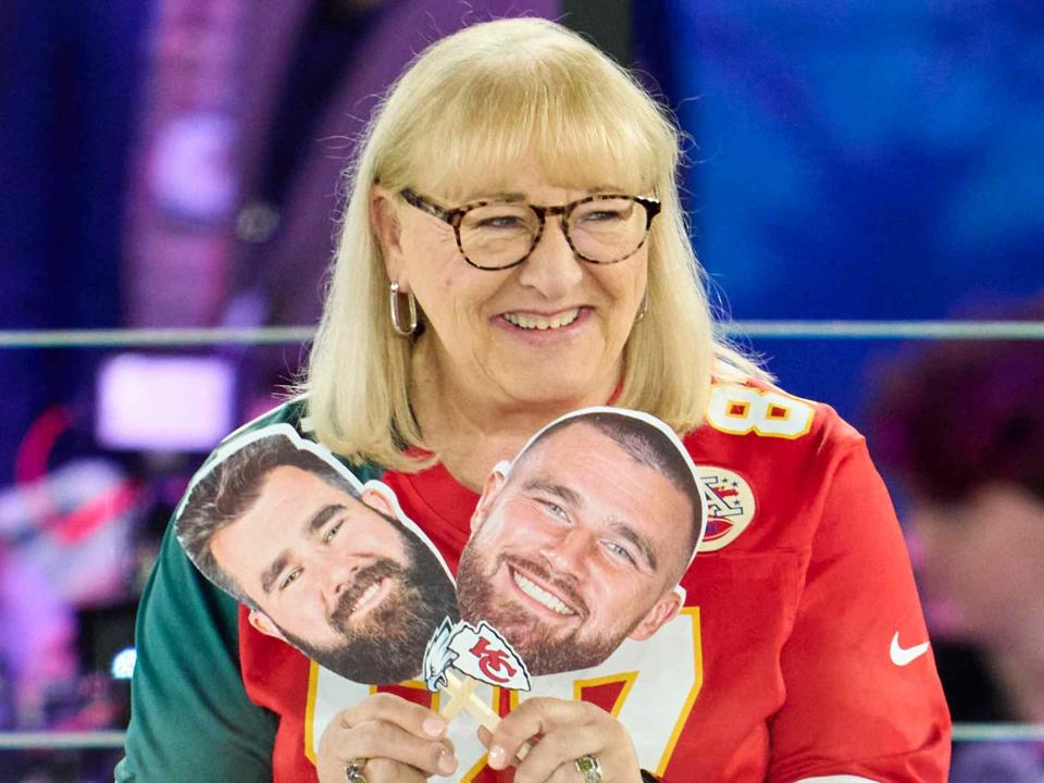 Cooper Neill/Getty Donna Kelce holds up photos of her sons, Jason Kelce #62 of the Philadelphia Eagles and Travis Kelce #87 of the Kansas City Chiefs at Footprint Center on February 6, 2023 in Phoenix, Arizona