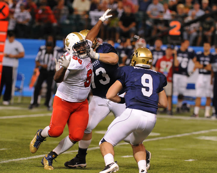 ST. PETERSBURG, FL - JANUARY 21: Defemsive lineman Jabaree Tuani #98 of the U. S. Naval Academy Midshipmen pressures quarterback Tyler Hansen of the University of Colorado Buffaloes during the 87th annual East-West Shrine game January 21, 2012 at Tropicana Field in St. Petersburg, Florida. (Photo by Al Messerschmidt/Getty Images)