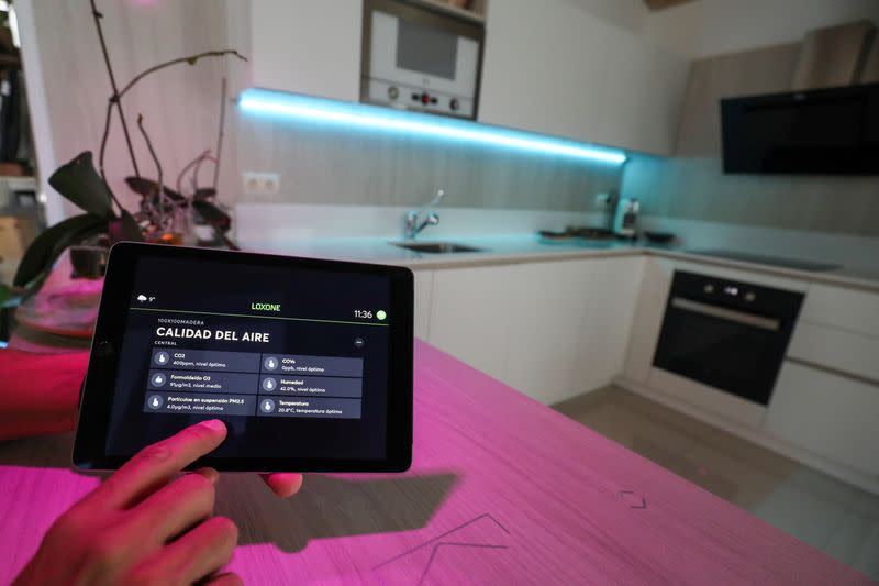 Echevarria, founder of the building company specialised in all-wood, low-emission homes100x100 Madera, points out on a screen on an iPad, in Guadalix de la Sierra