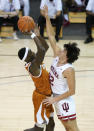 Texas guard Courtney Ramey (3) drives to the basket against Indiana guard Trey Galloway (32) in the first half of a semifinal NCAA college basketball game in the Maui Invitational tournament, Tuesday, Dec. 1, 2020, in Asheville, N.C. (AP Photo/Kathy Kmonicek)