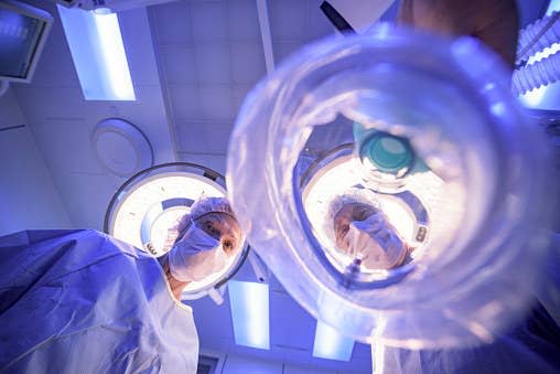 Doctors looking down at a patient as they're about to go under.