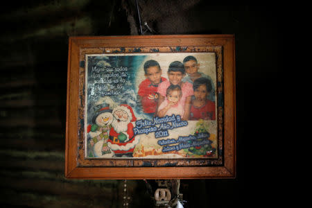 A family photograph hangs in Maria Guitia's home near San Francisco de Yare, Venezuela, February 20, 2019. REUTERS/Carlos Garcia Rawlins