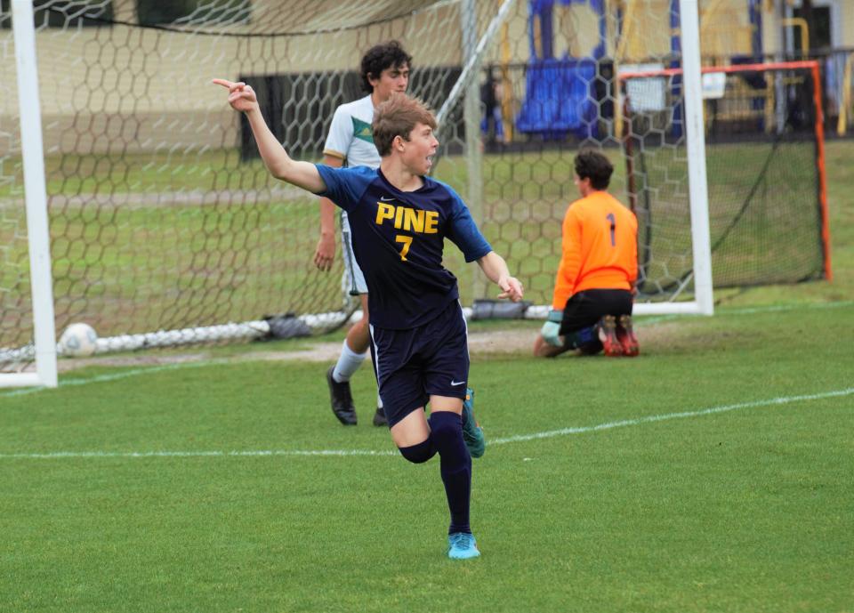 Pine School senior forward Xavier Csato celebrates a goal in the second half of a 2A state semifinal on Saturday, Feb. 19, 2022 in Hobe Sound. Pine School won 6-0 to advance to the 2A state championship match.