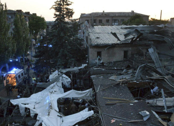 In this photo provided by the National Police of Ukraine, people clear the rubble in a restaurant RIA Pizza destroyed by a Russian attack in Kramatorsk, Ukraine, Tuesday, June 27, 2023. (National Police of Ukraine via AP)