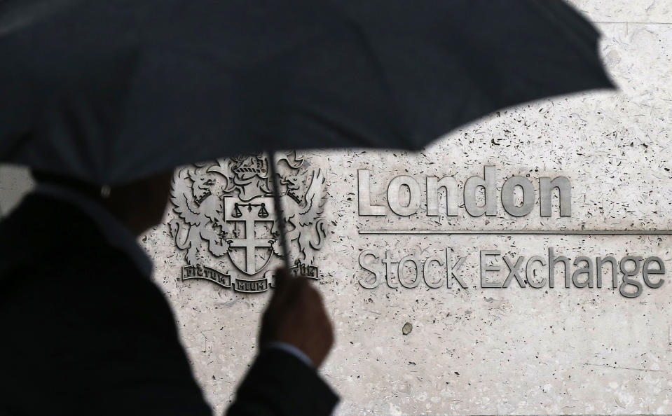 A man shelters under an umbrella as he walks past the London Stock Exchange in London, Britain August 24, 2015. World stock markets plunged on Monday, as a near 9-percent dive in China shares and a sharp drop in the dollar and major commodities sent investors rushing for the exit. The Dow Jones Industrial Average dropped more than 1,000 points as Wall Street opened, and the benchmark Standard & Poor's 500 index slid more than 2.5 percent, a drop that puts it nearly 10 percent below its record high.  REUTERS/Suzanne Plunkett 