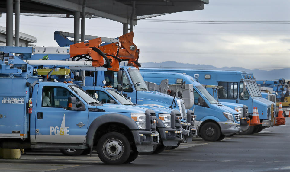 FILE - In this Jan. 14, 2019 file photo, Pacific Gas & Electric vehicles are parked at the PG&E Oakland Service Center in Oakland, Calif. U.S. prosecutors are urging a federal judge to work with a court-appointed monitor to determine ways Pacific Gas & Electric Co. can prevent its equipment from starting more wildfires. In a court filing Wednesday, Jan. 23, 2019, the U.S. attorney's office in San Francisco said Judge William Alsup should refrain from immediately imposing new requirements on the utility. (AP Photo/Ben Margot, File)