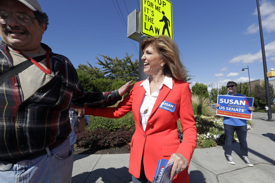 In this Monday, Sept. 17, 2018 photo, Republican U.S. Senate candidate Susan Hutchison greets Boeing workers as she campaigns outside a plant in Renton, Wash. Hutchison, who spent two decades as a Seattle TV news anchor before leading the state GOP party for five years, is running against Democratic incumbent Sen. Maria Cantwell. (AP Photo/Elaine Thompson)