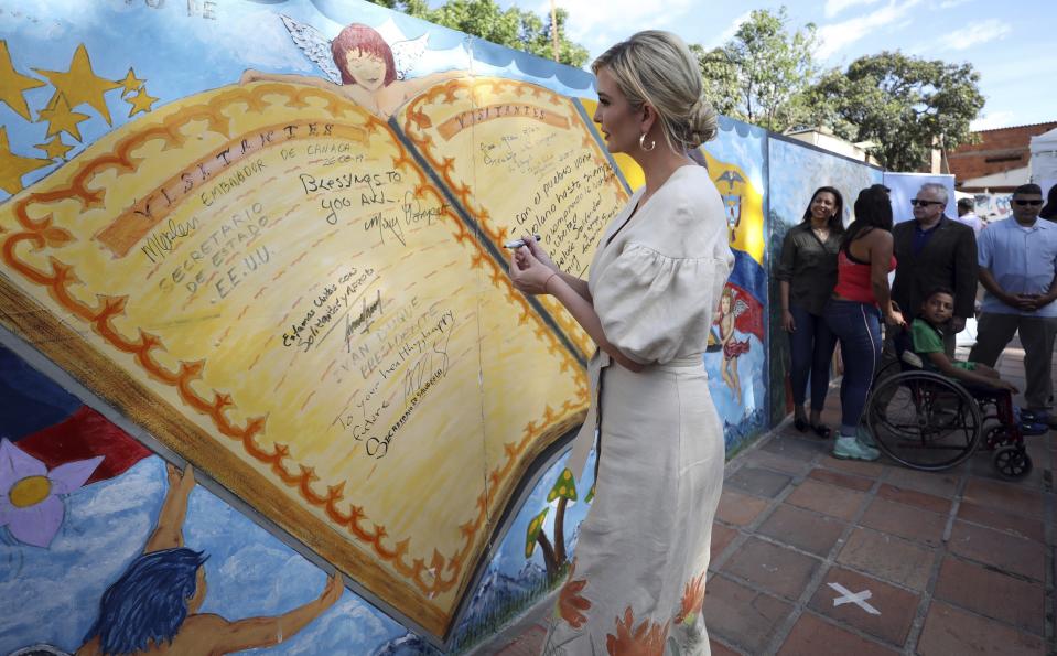 Ivanka Trump, President Donald Trump's daughter and White House adviser, signs a mural at a migrant shelter in La Parada near Cucuta, Colombia, Wednesday, Sept. 4, 2019. Ivanka Trump is kicking off her trip to South America by promoting women's empowerment. (AP Photo/Fernando Vergara)