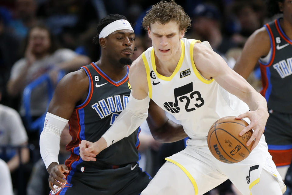 Utah Jazz forward Lauri Markkanen (23) tries to dribble past Oklahoma City Thunder guard Luguentz Dort during the first half of an NBA basketball game Friday, March, 3, 2023, in Oklahoma City. (AP Photo/Nate Billings)