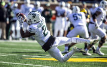 FILE - In this Nov. 16, 2019, file photo, Michigan State wide receiver Julian Barnett (2) makes a catch in the first quarter of an NCAA college football game against Michigan in Ann Arbor, Mich. Big Ten is going to give fall football a shot after all. Less than five weeks after pushing football and other fall sports to spring in the name of player safety during the pandemic, the conference changed course Wednesday, Sept. 16, 2020, and said it plans to begin its season the weekend of Oct. 23-24. (AP Photo/Tony Ding)