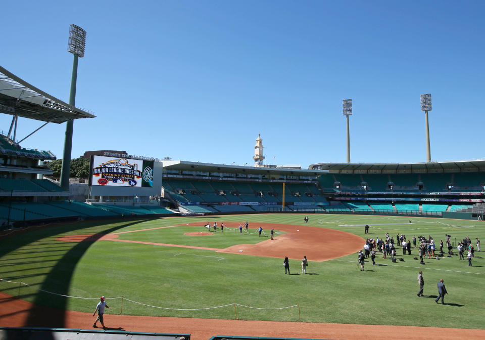 Ground staff prepare the baseball field that has been especially built for the Major League Baseball opening series at the Sydney Cricket Ground in Sydney, Monday, March 17, 2014. The MLB season-opening two-game series between the Los Angeles Dodgers and Arizona Diamondbacks in Sydney will be played this weekend. (AP Photo/Rick Rycroft)