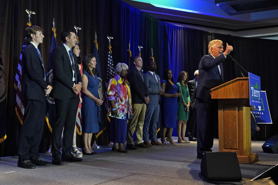 Winner of the Virginia Democratic gubernatorial primary, former Virginia Gov. Terry McAuliffe, right, addresses the crowd during an election party in McLean, Va., Tuesday, June 8, 2021. McAuliffe faced four other Democrats in Tuesday's primary. (AP Photo/Steve Helber)