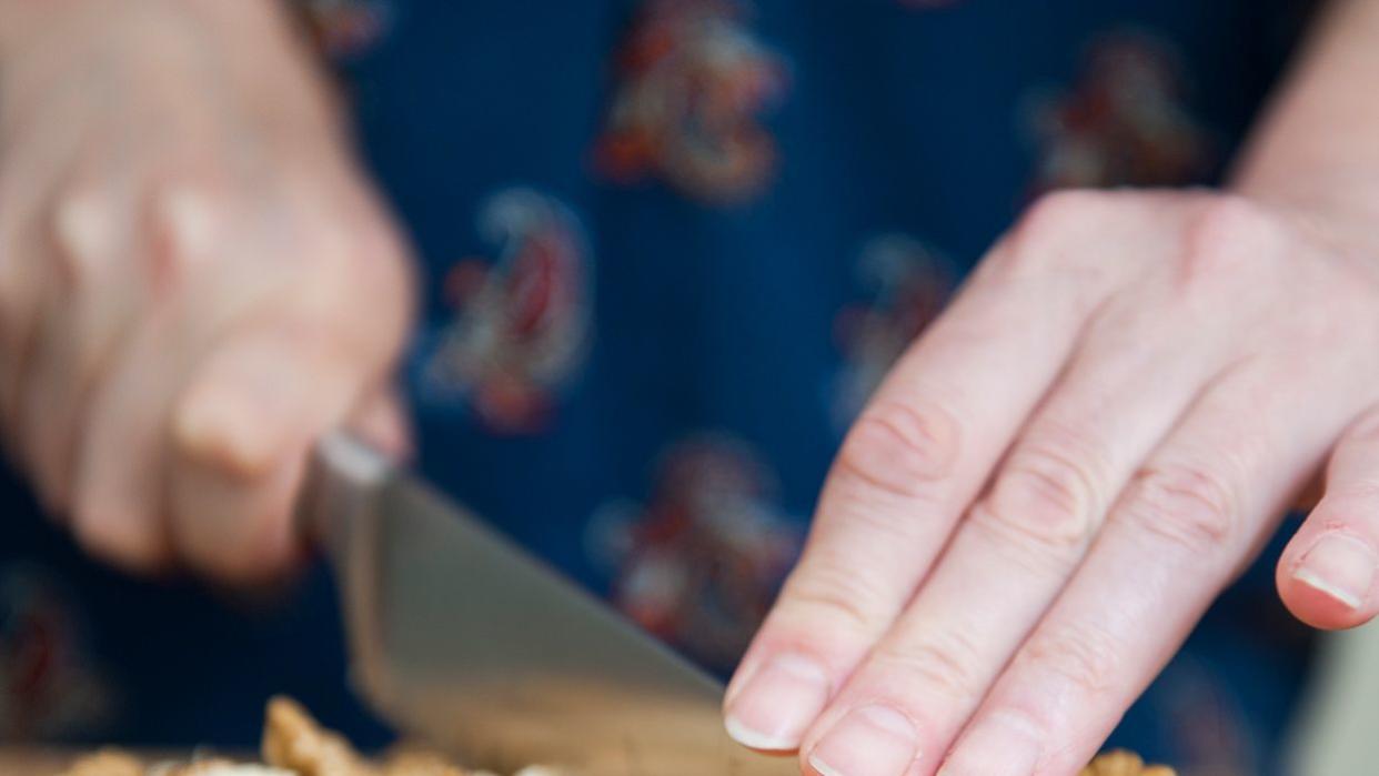 Woman chopping walnuts