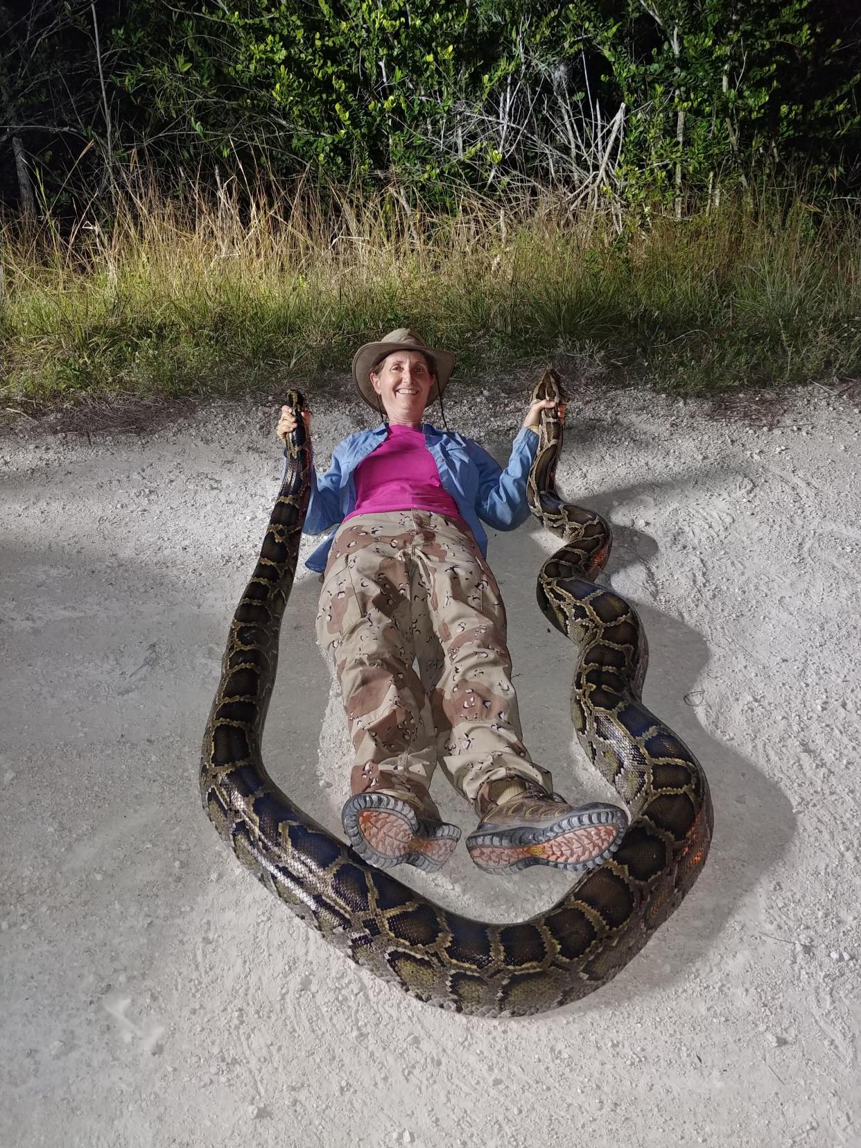 Donna Kalil poses with one of her catches. Kalil is a hunter with the South Florida Water Management District's python removal program. Contributed by Donna Kalil