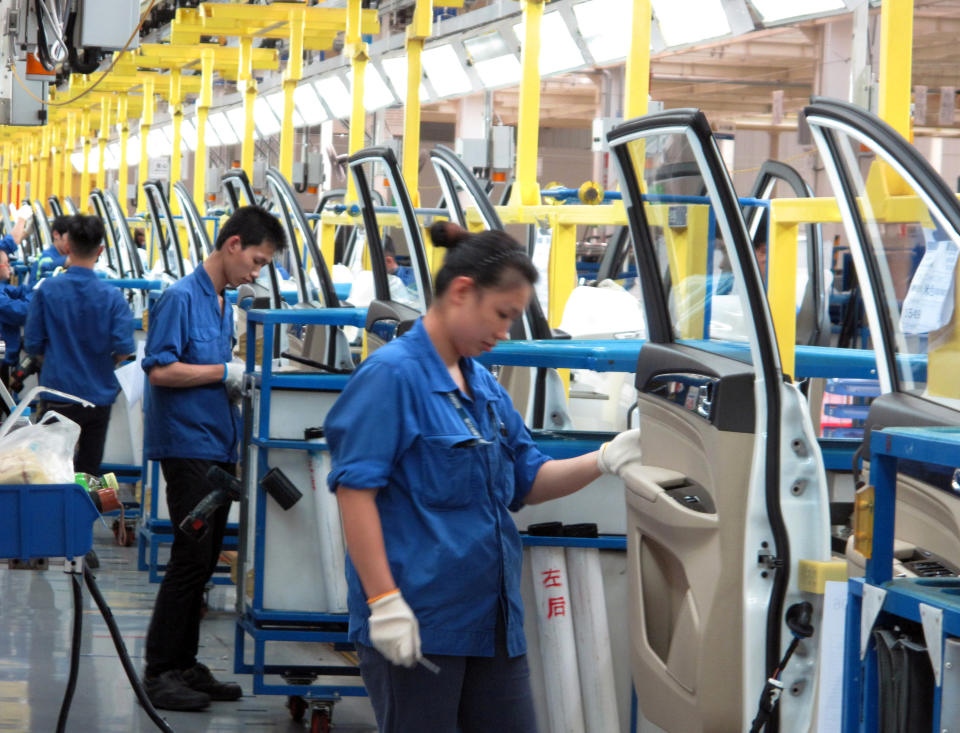 Employees work at a production line inside a factory of Saic GM Wuling, a joint venture of GM and local Chinese carmakers in Liuzhou, China. REUTERS/Norihiko Shirouzu