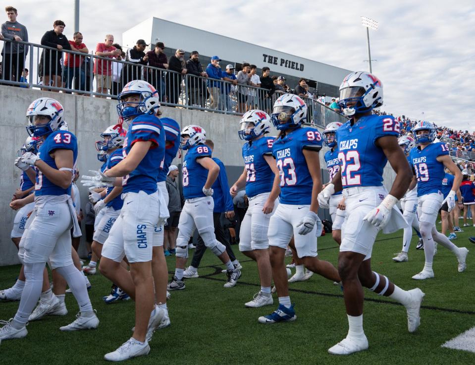 Members of the Westlake Chaparrals head to the locker room at halftime of their Class 6A Division I state semifinal game against Galena Park North Shore at the Pfield in Pflugerville on Dec. 9. The Chaps, led by Central Texas coach of the year Tony Salazar, went 14-1 this season.