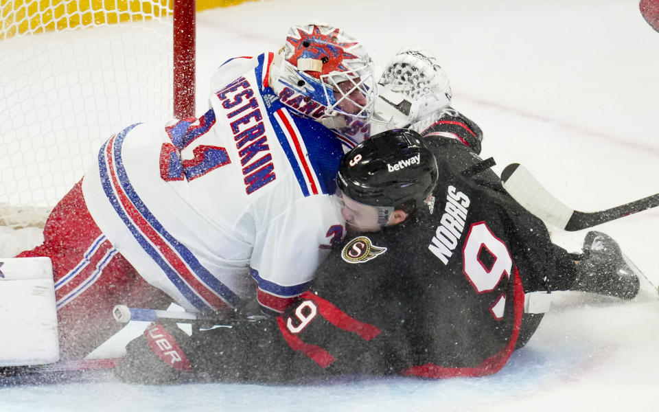 Ottawa Senators centre Josh Norris (9) crashes into New York Rangers goaltender Igor Shesterkin (31) during the second period of an NHL hockey game Tuesday, Dec. 5, 2023, in Ottawa, Ontario. (Sean Kilpatrick/The Canadian Press via AP)