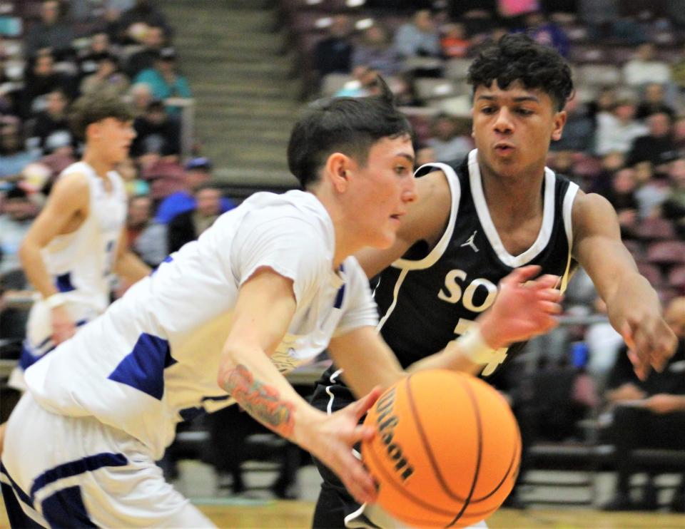 Maurice Austin of Pueblo South applies pressure defense on Ozzy Vigil of Pueblo Central in the Colts 55-31 victory over the Wildcats at Southwest Motor Event Center on Jan. 31, 2023
