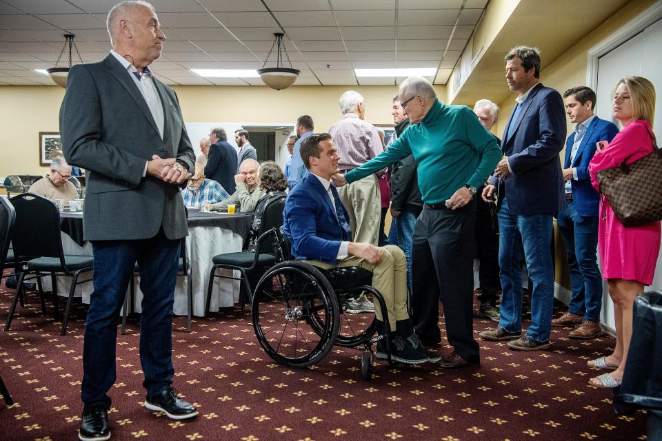 Rep. Madison Cawthorn talks with constituents before speaking at the Henderson County Republican Men’s Club meeting March 19, 2022 in Hendersonville.