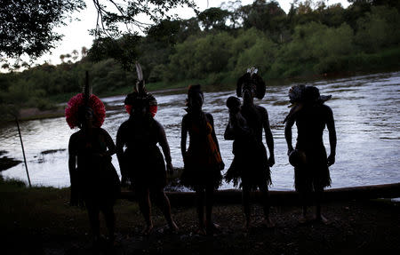 Indigenous people from the Pataxo Ha-ha-hae tribe are seen next to Paraopeba river, after a tailings dam owned by Brazilian mining company Vale SA collapsed, in Sao Joaquim de Bicas near Brumadinho, Brazil January 28, 2019. REUTERS/Adriano Machado