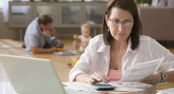 Caucasian woman paying bills on computer