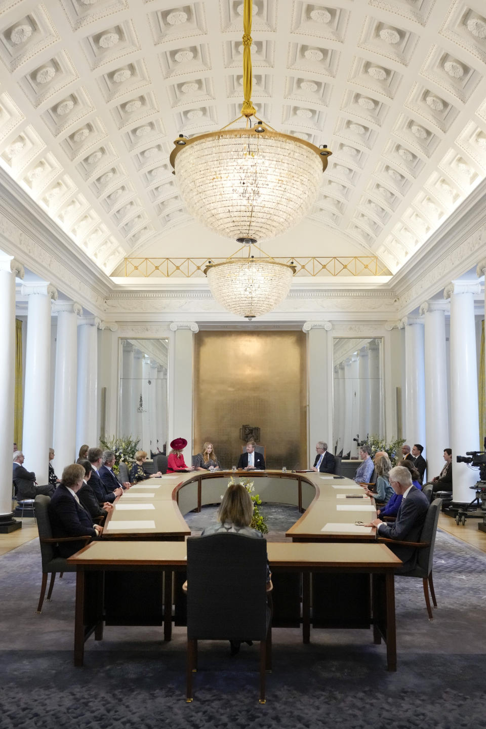 Heir to the Dutch throne Princess Amalia, center rear left, speeches as she takes an honorary seat at the Council of State, the highest government advisory body, while her mother Queen Maxima, left in red, and father King Willem-Alexander, rear center, listen, in The Hague, Netherlands, Wednesday, Dec. 8, 2021, one day after celebrating her eighteenth birthday. (AP Photo/Peter Dejong, Pool)