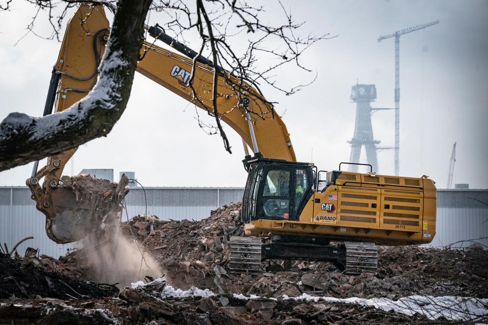 Southwestern High School in southwest Detroit is in the final phase of being completely demolished on Jan. 26, 2023. The footer of the new Gordie Howe Bridge can be seen in the background.