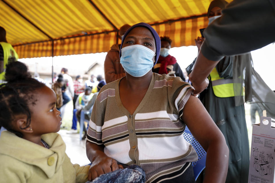 A Kenyan woman receives a dose of AstraZeneca coronavirus vaccine donated by Britain, at the Makongeni Estate in Nairobi, Kenya Saturday, Aug. 14, 2021. In late June, the international system for sharing coronavirus vaccines sent about 530,000 doses to Britain – more than double the amount sent that month to the entire continent of Africa. It was the latest example of how a system that was supposed to guarantee low and middle-income countries vaccines is failing, leaving them at the mercy of haphazard donations from rich countries. (AP Photo/Brian Inganga)