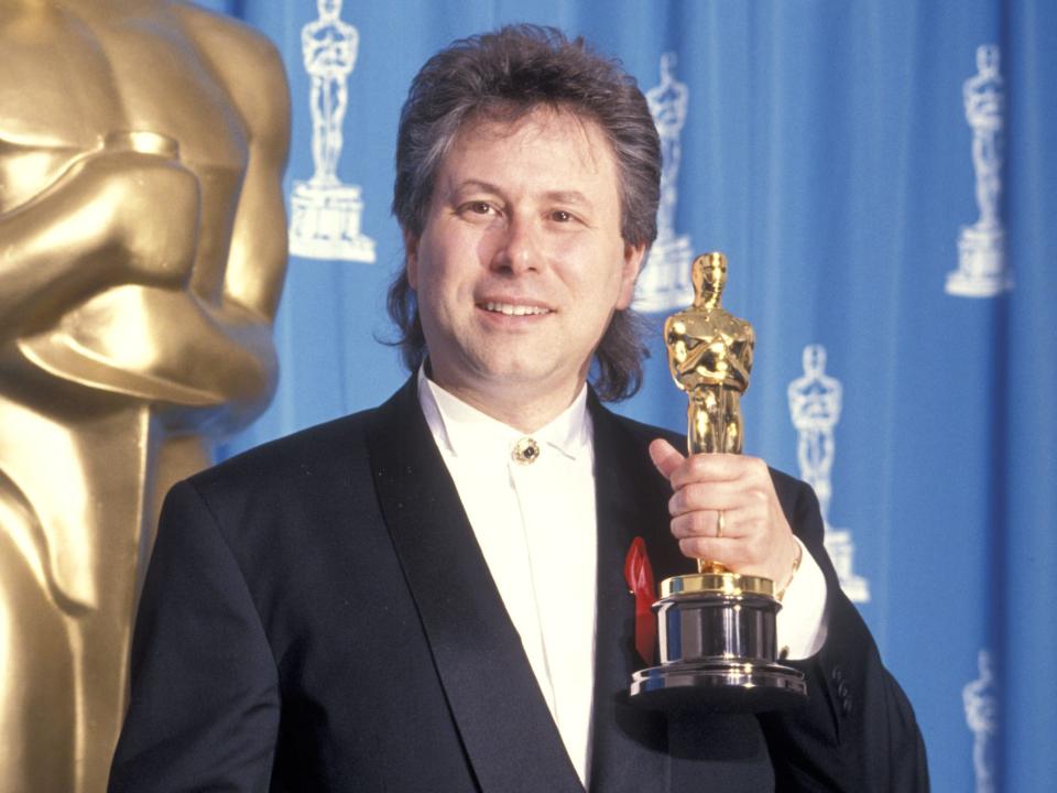 Alan Menken holds up his Oscar for best original score for "Aladdin" at the 1992 Academy Awards