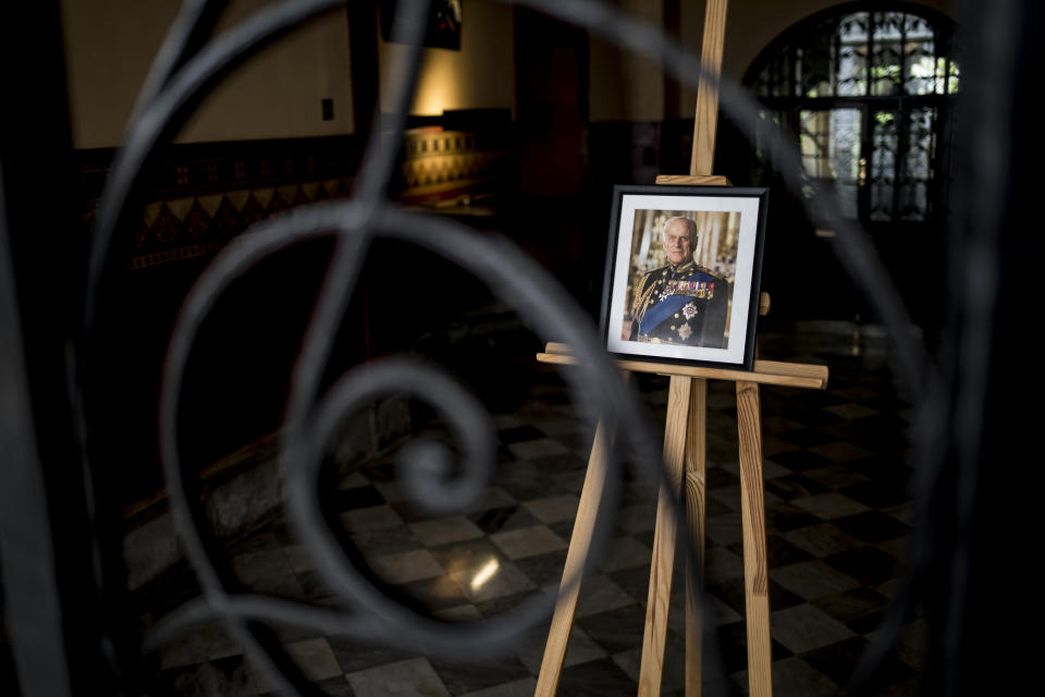 A portrait of Prince Phillip on display at Governor's house, in Gibraltar, Saturday April 10, 2021. Britain's Prince Philip, the irascible and tough-minded husband of Queen Elizabeth II who spent more than seven decades supporting his wife in a role that mostly defined his life, died on Friday. (AP Photo/Javier Fergo)