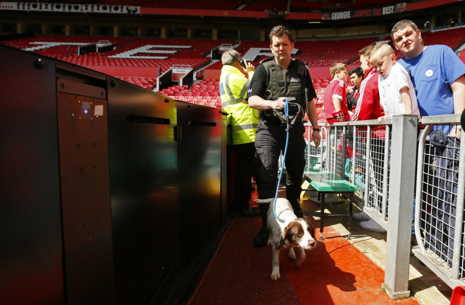 Police use sniffer dogs as fans are evacuated from Old Trafford stadium before the Barclays Premier League match between Manchester United and AFC Bournemouth in Manchester, England, on May 15, 2016. (Jason Cairnduff/Livepic/Action Images via Reuters)