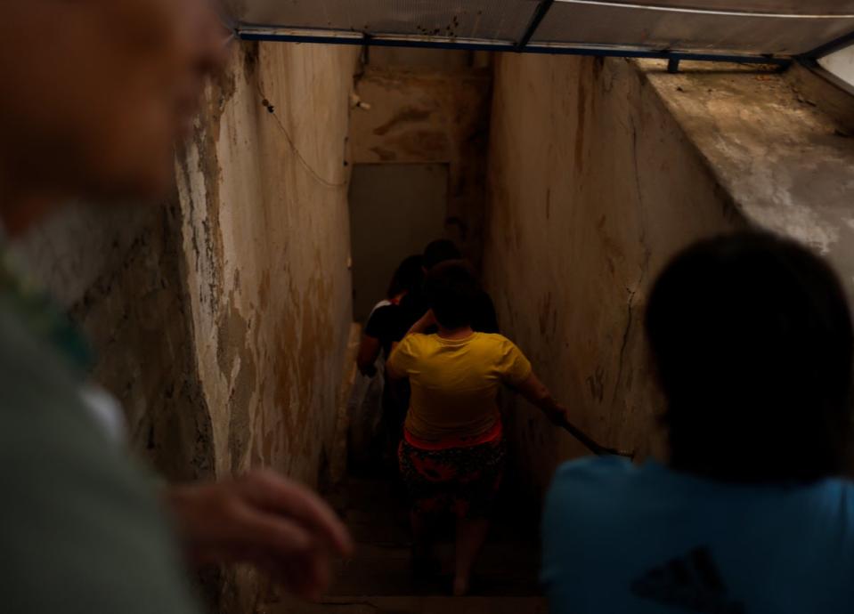 Children take the stairs to the basement (Reuters)