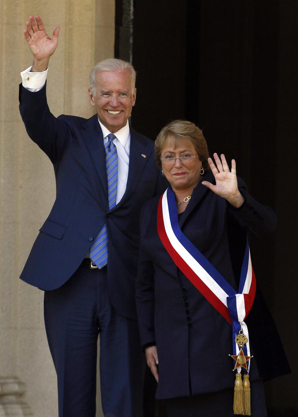 Vice President Joe Biden and Chile's newly sworn-in President Michelle Bachelet pose for photos on the front steps of the Cerro Castillo presidential residence, in Vina del Mar, Chile on Tuesday, March 11, 2014. Bachelet, who led Chile from 2006-2010, was sworn-in as president on Tuesday. (AP Photo/Luis Hidalgo)