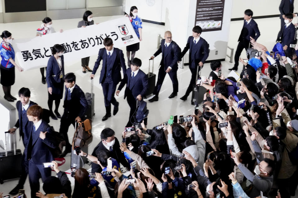 Supporters welcome home Japanese national soccer team from the World Cup in Qatar, at Narita International Airport in Narita, east of Tokyo, Wednesday, Dec. 7, 2022.(AP Photo/Shuji Kajiyama)