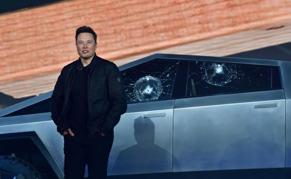 Tesla co-founder and CEO Elon Musk stands in front of the shattered windows of the newly unveiled all-electric battery-powered Tesla’s Cybertruck at Tesla Design Center in Hawthorne, California on November 21, 2019 (AFP via Getty Images)