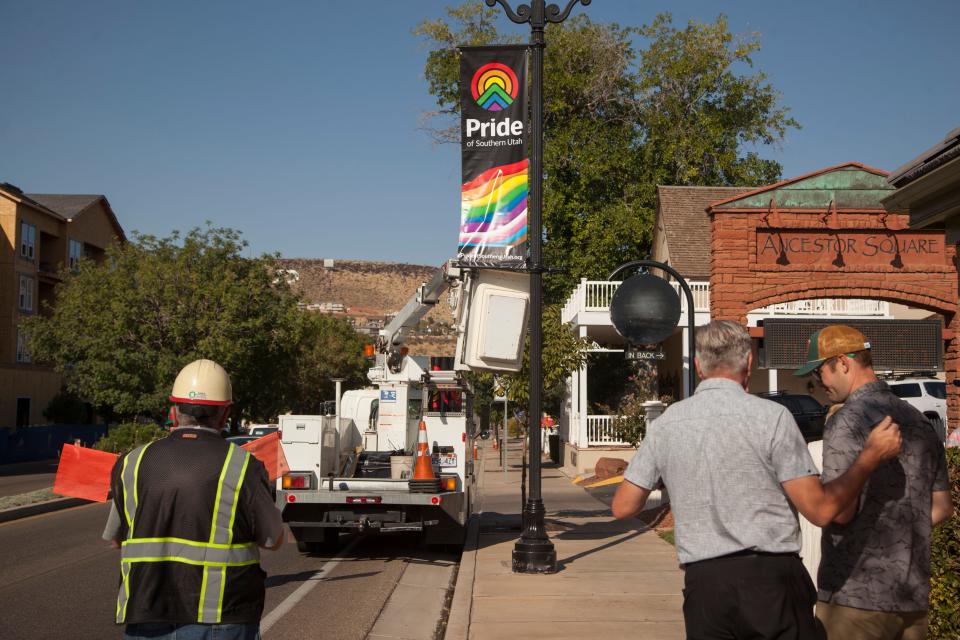 Stephen Lambert, Pride of Southern Utah Director, and pride banner designer Lee Boren watch as workers place pride banners on St. George Boulevard in anticipation of Pride Week Monday, Sept. 9, 2019.