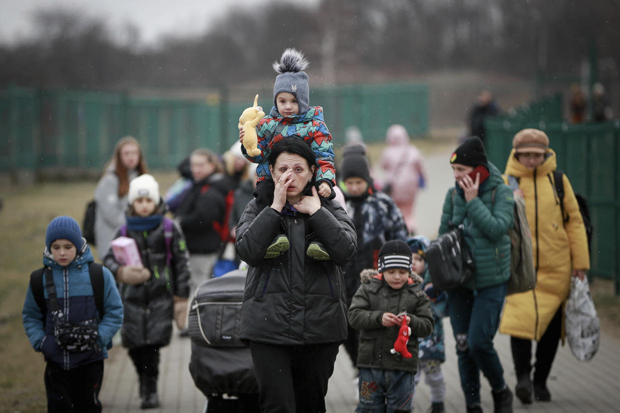 Refugees, mostly women with children, arrive at the border crossing in Medyka, Poland, Saturday, March 5, 2022, after fleeing Russian invasion in Ukraine. (AP Photo/Visar Kryeziu)