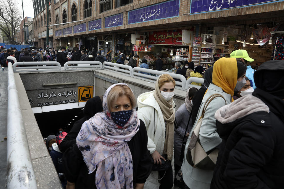 Mask-clad commuters leave a metro station at Tehran's Grand Bazaar, ahead of the Persian New Year, or Nowruz, meaning "New Day" in Iran, Monday, March 15, 2021. (AP Photo/Vahid Salemi)