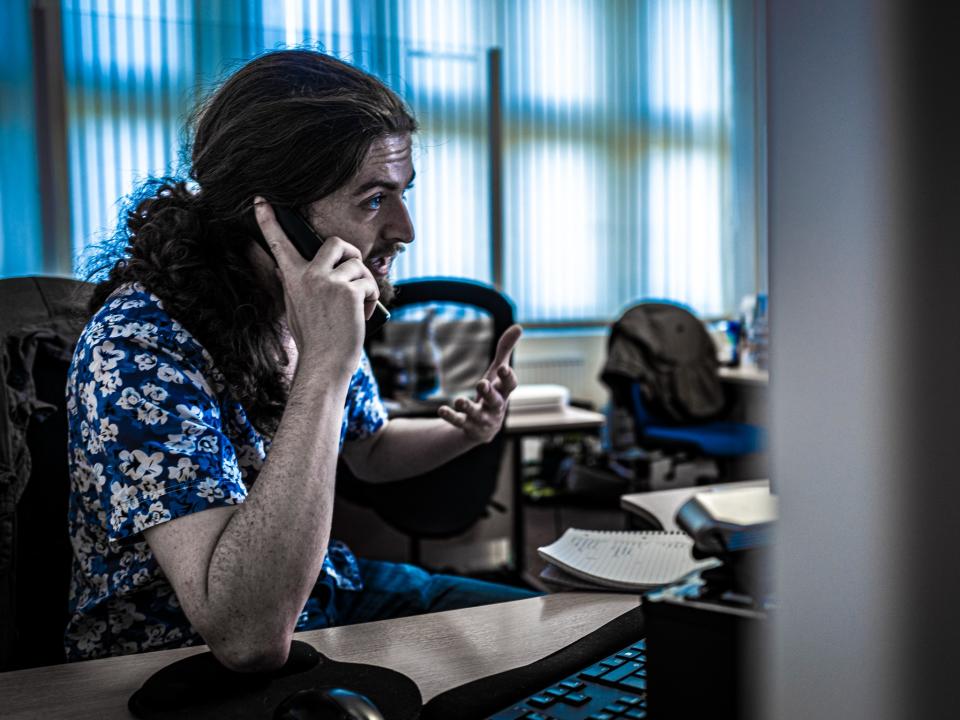 Conor Duckworth answers phones at Glass Doors headquarters, which had stayed open throughout the pandemic to offer advice and supportLisa Tse