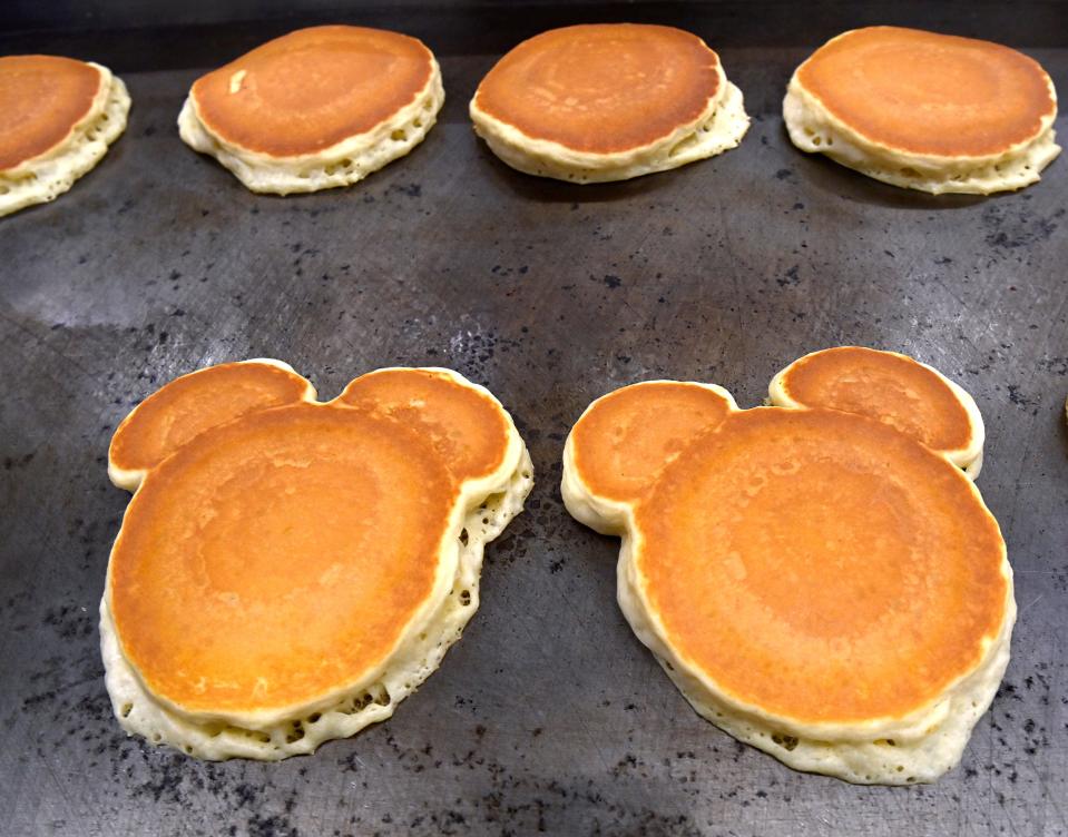 Mickey Mouse-shaped pancakes cook on a griddle Saturday in the Abilene Convention Center. The Abilene Kiwanis Club’s annual Pancake Day bolsters the fund the group uses to assist children’s charities and other causes throughout the year.