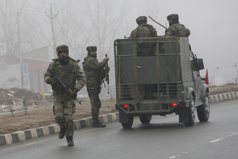 Indian army soldiers arrive at the site of Thursday's explosion in Pampore, Indian-controlled Kashmir, Friday, Feb. 15, 2019. Security officials say the death toll from a car bombing in Indian-controlled Kashmir has climbed to at least 40 after rebels fighting against Indian rule struck a paramilitary convoy in the single deadliest attack in the divided region's volatile history. (AP Photo/Dar Yasin)