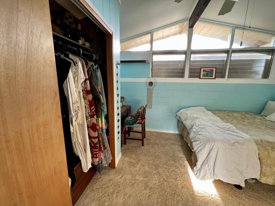 open closet an beige carpet between bed